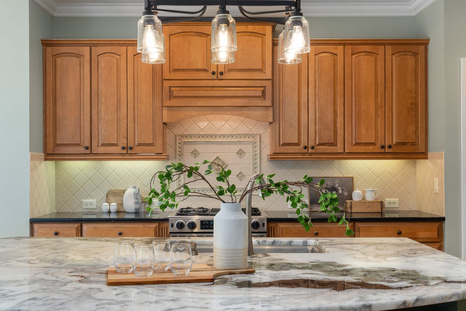U-shaped kitchen in a period house with inset painted cabinetry and a large range