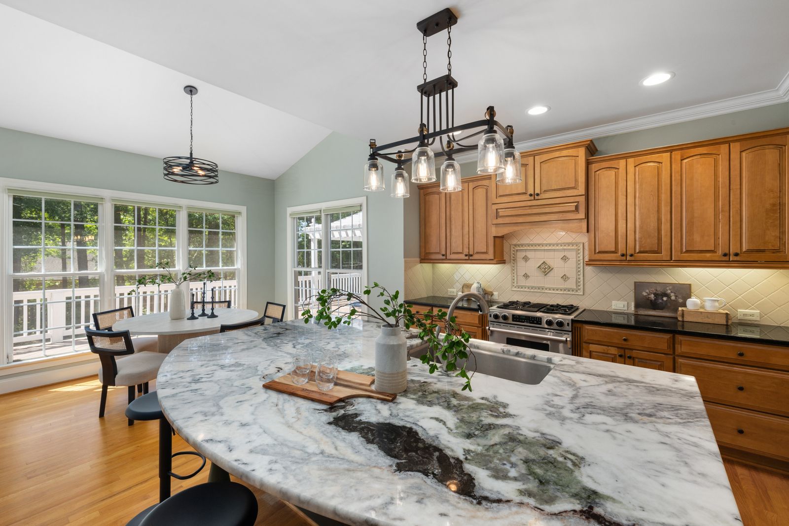 Narrow galley kitchen with pale cabinetry and a run of open shelving