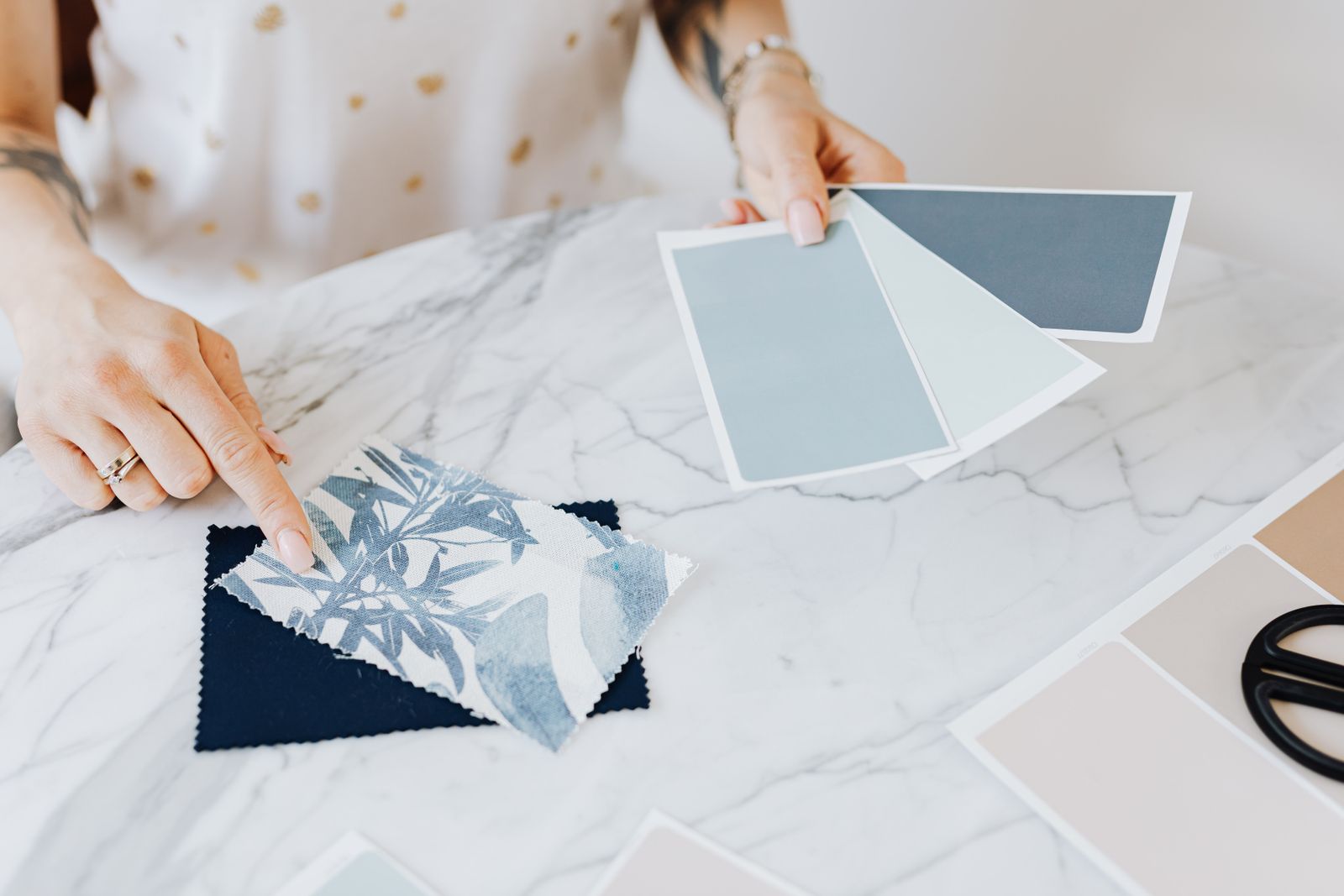 Studio table with material samples and a set of drawings